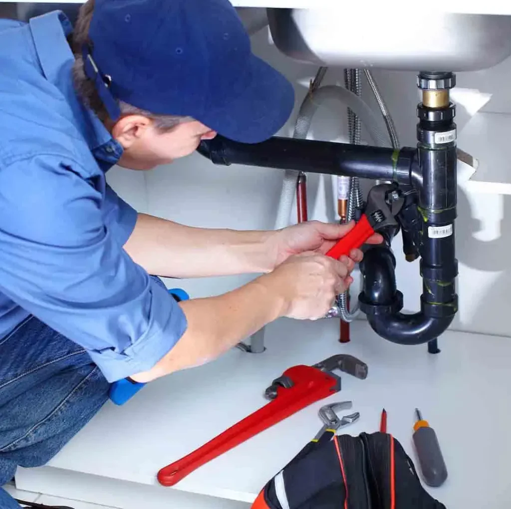 Plumber fixing a drain